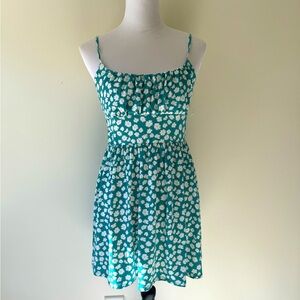 Babydoll style swing dress. Green and white floral print. Size medium